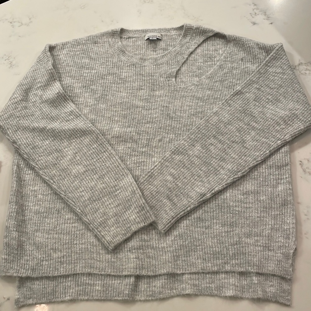 Sweater with cut out detail on chest/shoulder